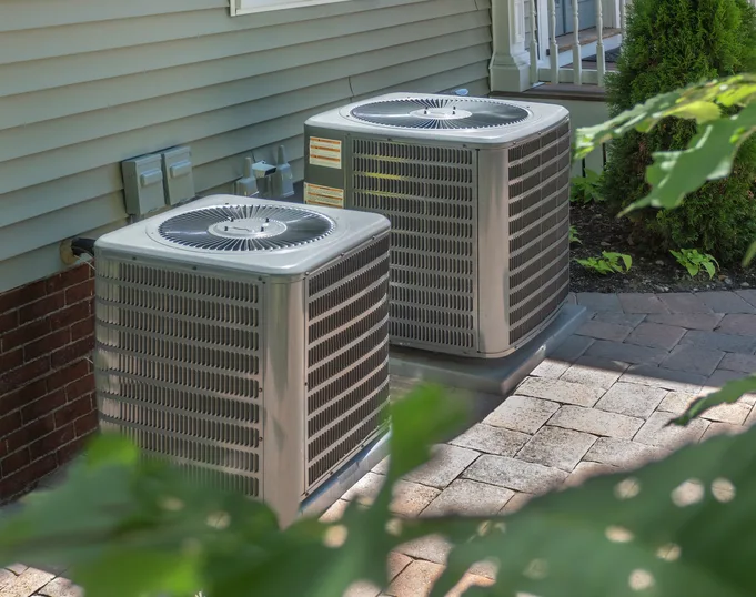 Central air conditioning condensers installed outside a Nokomis, FL home