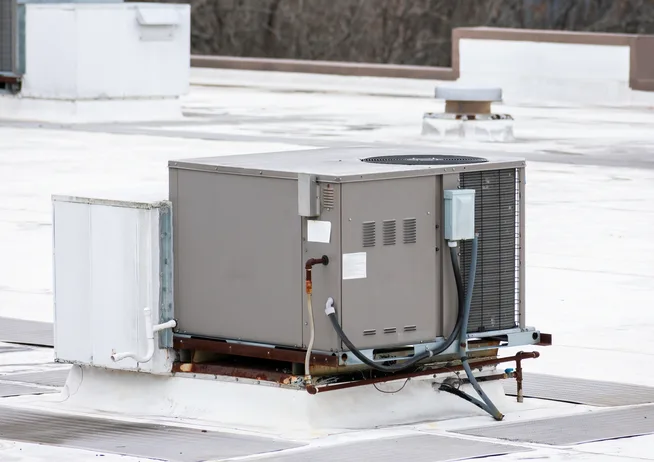 Commercial rooftop packaged HVAC units on a flat roof in Sarasota County